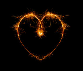heart, written with a sparkler on a black background