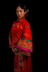 Fototapeta premium Ancient Asian brides in red on a black background