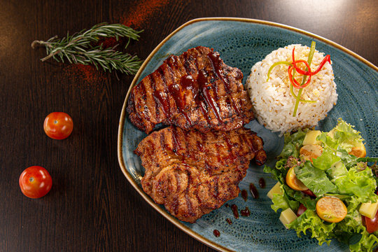 Carne a la parrilla con salsa BBQ, arroz y ensalada