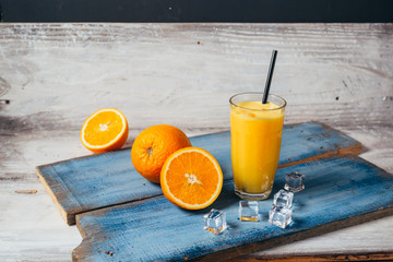 orange smoothie on wooden board