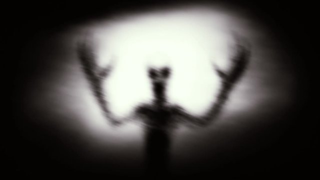 Scary dark room in alien spaceship and the silhouette of an humanoid against the background of light. Sci-fi horror animation with cinematic effect.