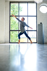 A handsome young male Ballet dancer practicing in a Loft style A