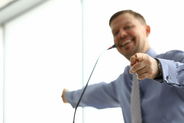 Smiling man points his finger towards microphone