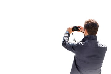 Young attractive man photographing the beautiful views in the city