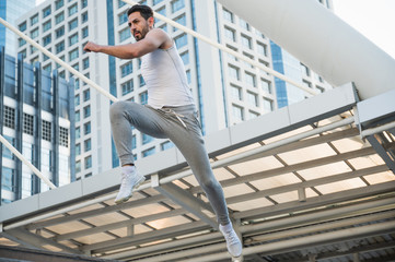 Young handsome sport man jumping training outdoors healthy lifestyle and sport concept.