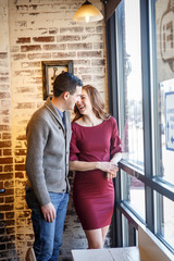 Pregnant couple in a cafe setting