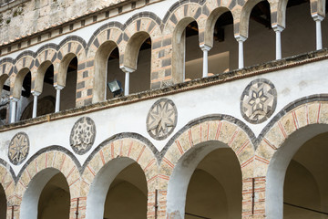 Fototapeta na wymiar Salerno, Italy. Exterior view of the colister of the San Matteo Cathedral with its medieval smixed styles. This is an exemple of arab-norman building from the 12th century.