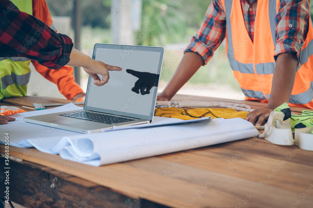Poster engineer working with laptop and blueprints,engineer inspection in construction site for architectur