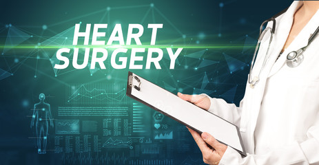 doctor writes notes on the clipboard with HEART SURGERY inscription, medical diagnosis concept