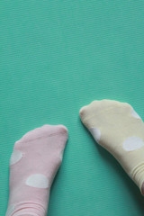 feet wearing different colored socks