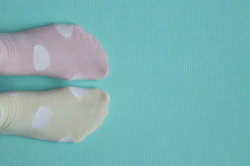 feet wearing different colored socks