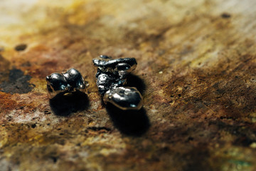 Pure silver pieces on a jeweler's desk ready to be shaped.