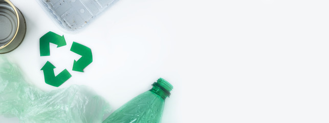 The green character of the environment and debris around on a background of white background. Concept of environmental protection. Long banner with space for text
