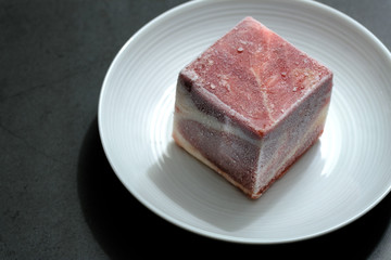 freezing raw beef cubes isolated on white plate view
