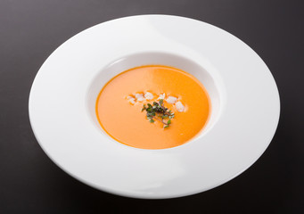 Orange pumpkin soup with prawns