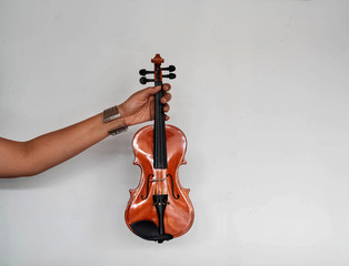 Fototapeta na wymiar Violin was holding by human hand