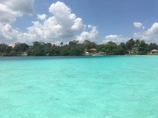Beautiful ocean view with clean blue turquoise water, sunny day. Amazing background of island, Caribbean, Lagoon Bacalar. Calm secluded place without people, paradise - 346890699