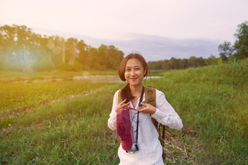      Girl holding a camera for tourism and nature