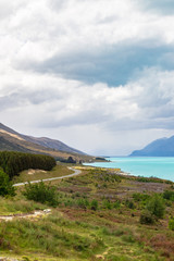 Road to the Southern Alps. Along the shore of the turquoise lake Pukaki. New Zealand