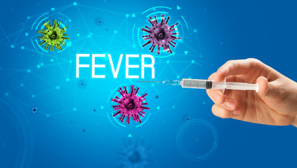 Syringe, medical injection in hand with FEVER inscription, coronavirus vaccine concept