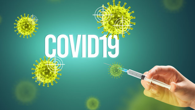 Close-up view of doctor's hand in a white glove holding syringe with COVID19 inscription, coronavirus antidote concept
