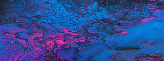 art photography of abstract marbleized effect background. Black, blue, pink and purple creative colors. Beautiful paint