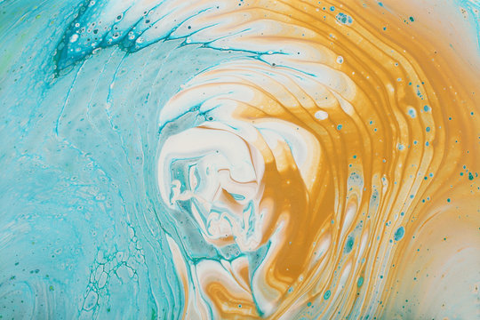art photography of abstract marbleized effect background. Aqua, blue, gold and white creative colors. Beautiful paint
