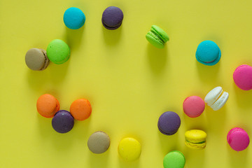 Sweet and colorful french macaroons or macaroon on yellow background, Dessert eating with tea or coffee