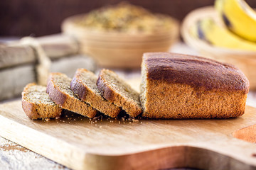 healthy, homemade vegan bread, banana flavor. Spot focus. Sliced ​​bread on rustic table.