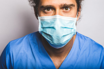 young adult wearing a medic mask and medic uniform