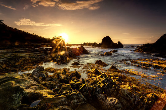 A Long Expose Magical Sunrise Shot with Flare, Lights the Rocks © Dimas