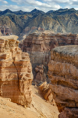 Small people on the huge rock in Charin Canyon in Kazakhstan 