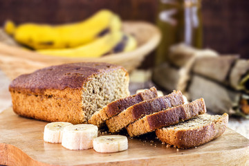 healthy, homemade vegan bread, banana flavor. Spot focus. Sliced ​​bread on rustic table.