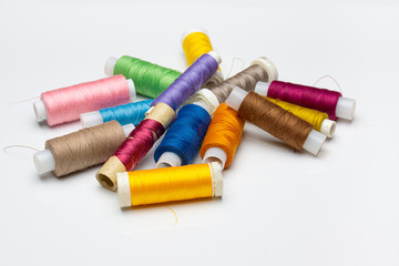 Coloured threads isolated on white background Closeup