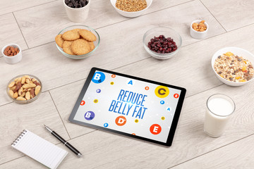 Healthy Tablet Pc compostion with REDUCE BELLY FAT inscription, weight loss concept