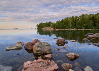 Spring walk along the Gulf of Finland on a wonderful calm morning in Lauttasaari next to the beautiful stones of Finnish nature.