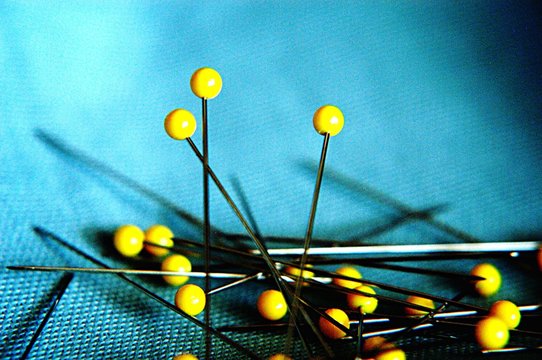 Close-up Of Sewing Pins On Fabric