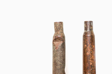 Old rusty rifle cartridges from the second world war on a white background.