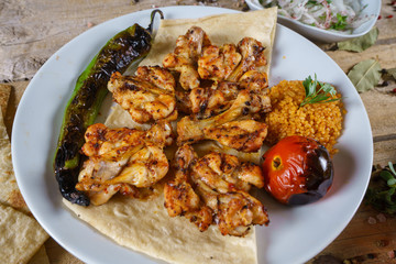 Kebabs - grilled meat and vegetables. Grilled chicken breast. Fried chicken fillet and fresh vegetable salad of tomatoes, cucumbers and arugula leaves.
Grilled chicken legs with spices and garlic.