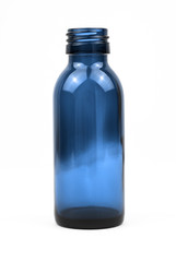 Classic clear blue glass bottle without a lid shot straight on in a white studio.