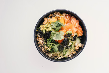 bowl with fish and greens on a white background

