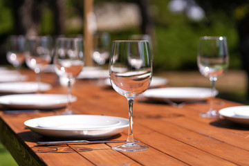 Served wooden table without a tablecloth. Cafe in the open air park