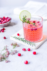 red fresh cocktail with berry and cut lime on stone desk background