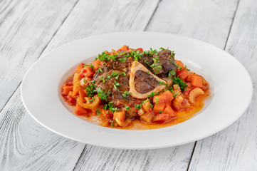 Ossobuco - Italian cuisine specialty with veal shanks and vegetables