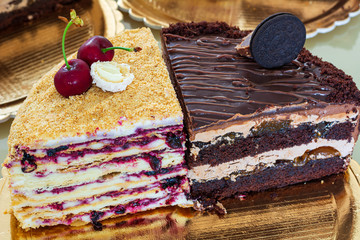 Slices of cakes . Cream cake and prague cake with fruit filling