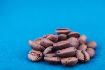roasted coffee beans on a blue fluffy carpet