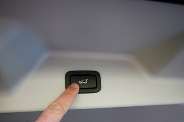Finger pressing trunk release button