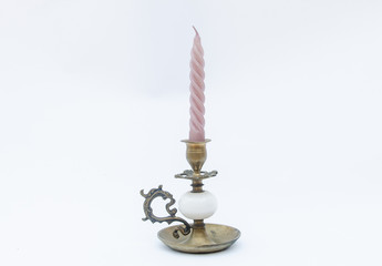 Vintage copper candlestick with pink candle - isolated on white background