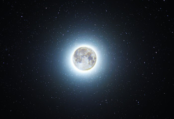 Full moon glowing in the starry sky. Night photography. Astronomical background. Deep space.