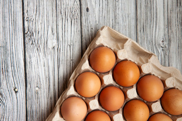 brown chicken eggs on a light wooden background